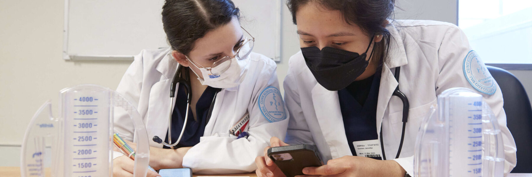 Two providers looking at a calculator