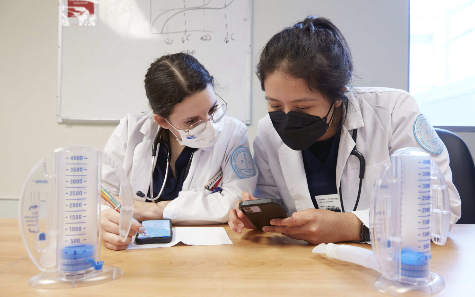 Two providers looking at a calculator
